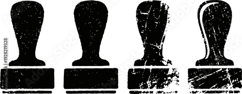 Four black vintage rubber stamps with wooden handles in a row, distressed grunge