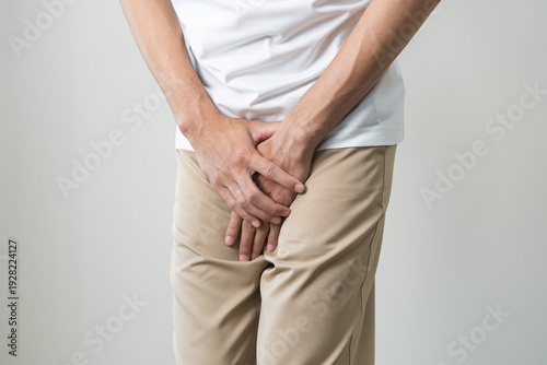 Obraz na plátně Closeup annoying itch asian man with an itchy his jock and butt, male scratching crotch with his hand, itching groin, male suffering body problem