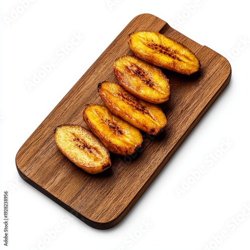 Sliced roasted plantains with caramelized sugar on a wooden cutting board, tropical healthy snack or dessert, close-up food photography, natural lighting