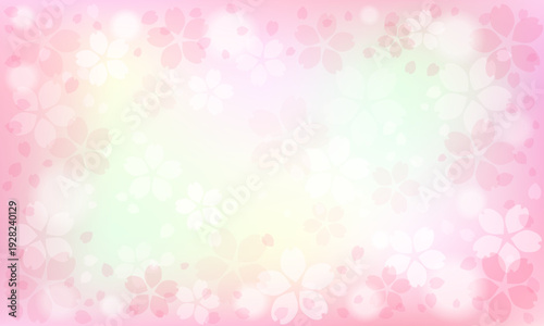 柔らかいピンクのグラデーションと舞い散る花びらが美しい桜の背景