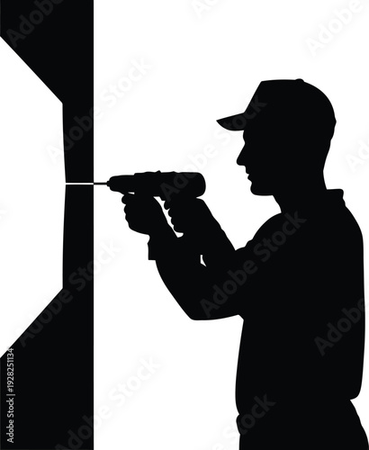 Silhouette of Worker Using Electric Drill for Construction and Home Improvement Projects