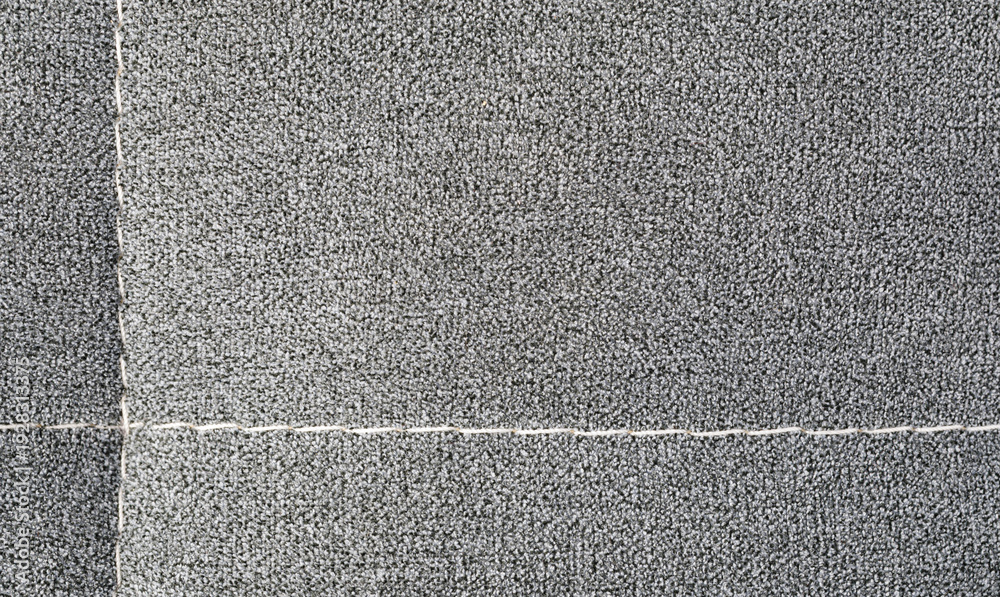 Fototapeta premium Gray carpet texture with intersecting white seams