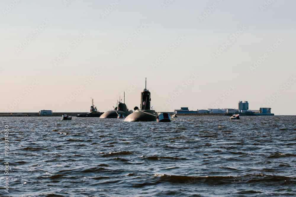 Naklejka premium View from the water of nuclear submarines in the waters of the Gulf of Finland.Preparation for the military parade on the Day of the Navy in Kronstadt.A missile submarine