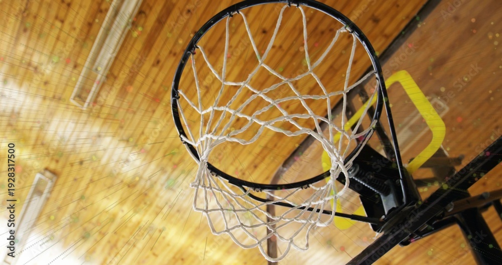 Fototapeta premium Showing basketball hoop assembly hanging from gym ceiling, featuring black rim white net yellow pad