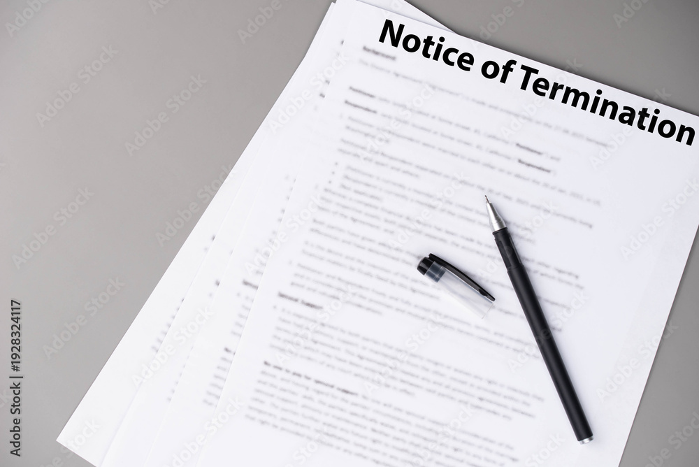 Obraz premium Notice of termination document on office desk, official HR paper announcing job dismissal or contract ending, symbol of decision, change, and professional transition.