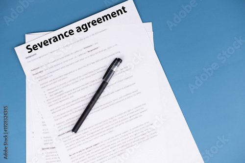 Severance agreement document on office desk, legal contract detailing terms of job termination and severance pay, symbol of closure, protection, and career transition in professional life.