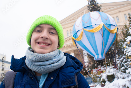 Photography happy teenage boy smiling by christmas hot air balloon decoration near bolshoi t
