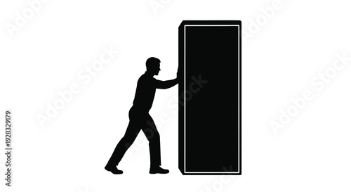 Man pushing a large dark rectangular object stark silhouette
