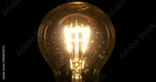 Glowing Light Bulb in Darkness Fades.