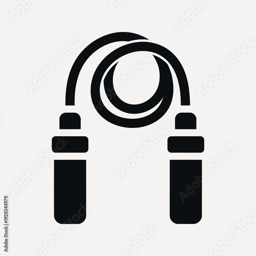 Black jump rope with rounded handles coiled in a loop against a light gray background skipping rope