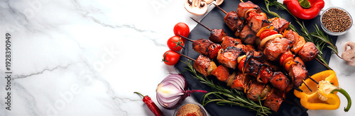 Delicious grilled meat and vegetable skewers on a marble surface