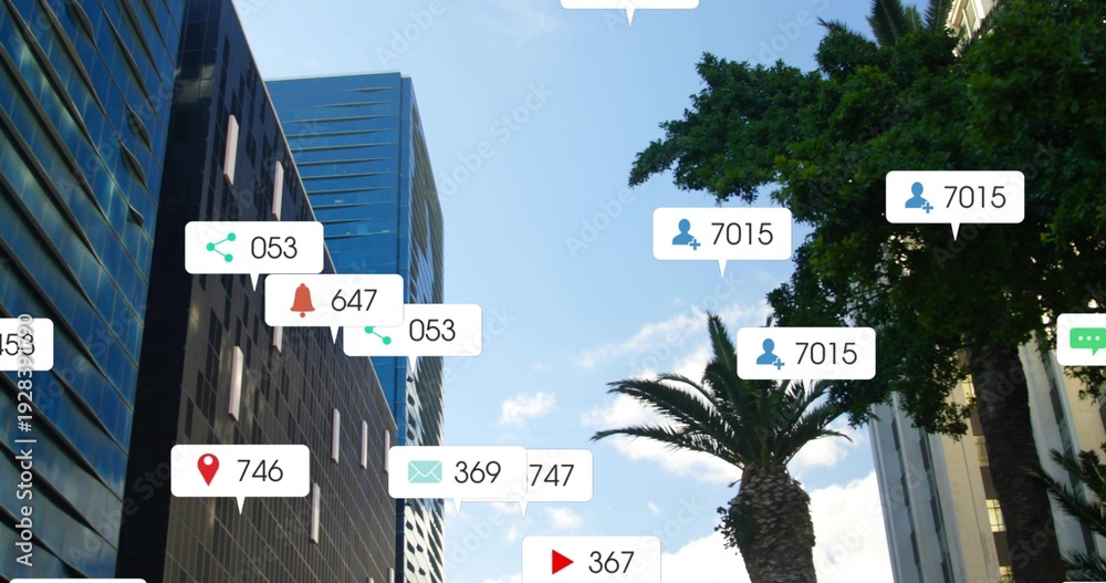Naklejka premium Overlaying white notification bubbles with icons and number badges hovering over downtown canyon