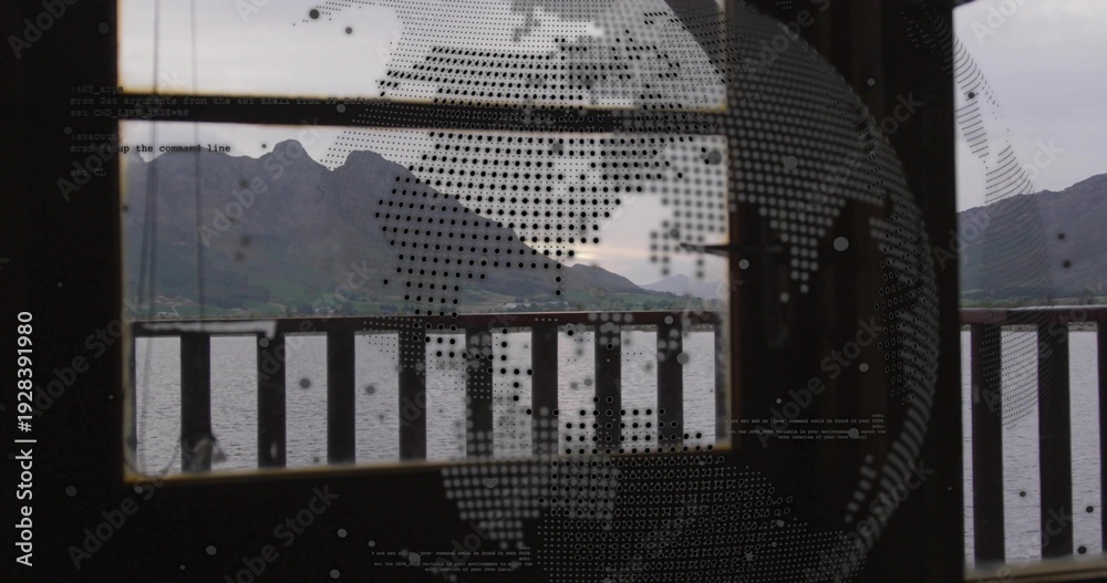 Obraz premium Framing centered mountain range through glass with dotted globe, faint text, wood railing and water