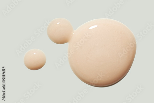 Beauty product beige nude serum gel isolated on neutral primer grey background