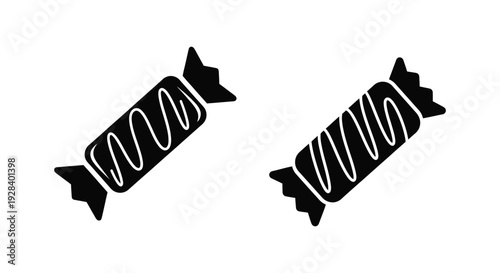 Two wrapped candies shown in a striking black silhouette