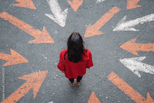 Girl standing on asphalt among arrows pointing in different directions, top view, symbolic scene of path choice, life decision, future and uncertainty