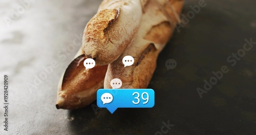 Displaying three crusty baguettes resting on dark countertop, showing white speech bubbles, blue 39