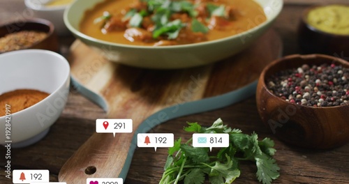 Showing blue-edged board topped by cilantro, resting on kitchen table with spice bowls and badges