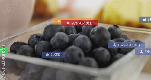 Displaying glass bowl filled with blueberries on kitchen table, showing SUBSCRIBED, LIKED icons