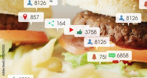 Showing stacked burger with sesame bun, beef patty at tabletop, tomato lettuce fries callouts