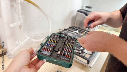 Schilderij op canvas Silent kitchen tinkering unfolds as a Caucasian male's hands orchestrate a delic