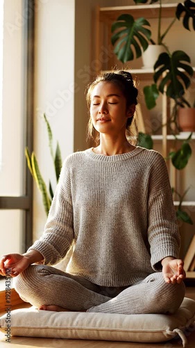 Wallpaper Mural A serene woman meditates cross-legged on a cushion in a bright room with plants Torontodigital.ca