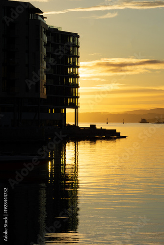 Photography Golden sunset reflection at Tjuvholmen waterfront in Oslo Norway
