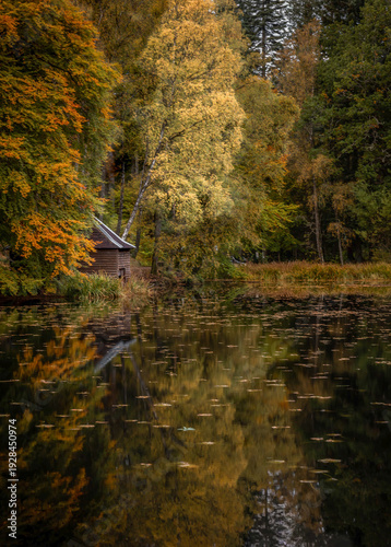 Loch Dunmore in Faskally Forest, near Pitlochry, Scotland, autumn, small boathouse between trees