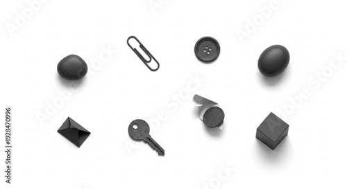 Collection of various black objects including spheres geometric shapes and office supplies on white background soft lighting subtle shadows studio setting