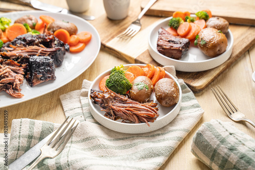 Fotografie Hearty Midwestern food. Beef pot roast with carrots and potatoes