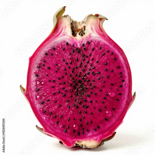 A halved red dragon fruit reveals intense magenta pulp dotted with numerous small black seeds isolated on a white surface.