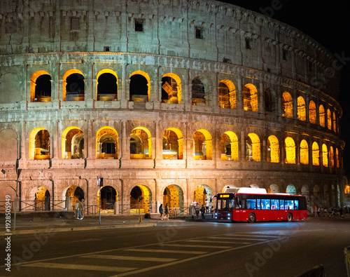 Photography Colosseum at night in Rome, Italy, with red bus