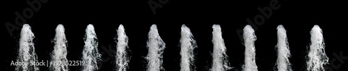 Water jet rising up and splashing on a black background, abstract