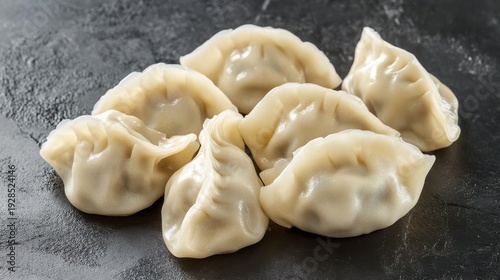 Steaming Dumplings Arranged on a Dark Textured Surface