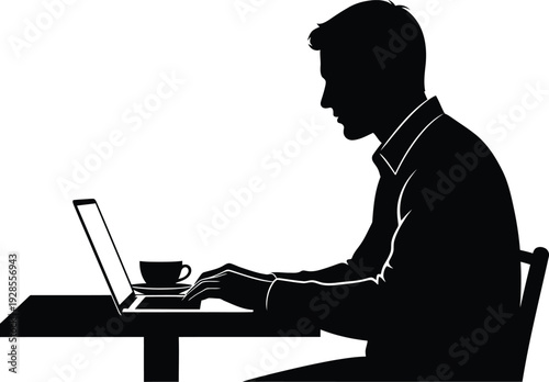Silhouette of a man working on a laptop at a desk