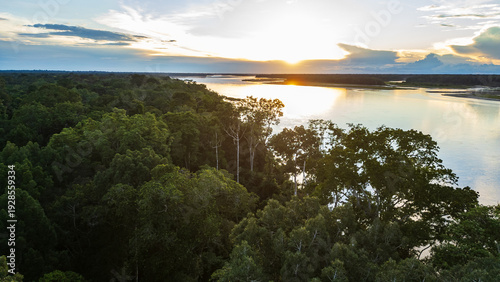 Golden sunset over the Amazon rainforest along the Napo River in Loreto, Peru.