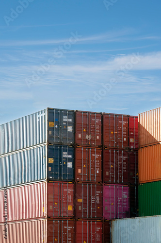 Shipping containers stacked in a busy cargo yard