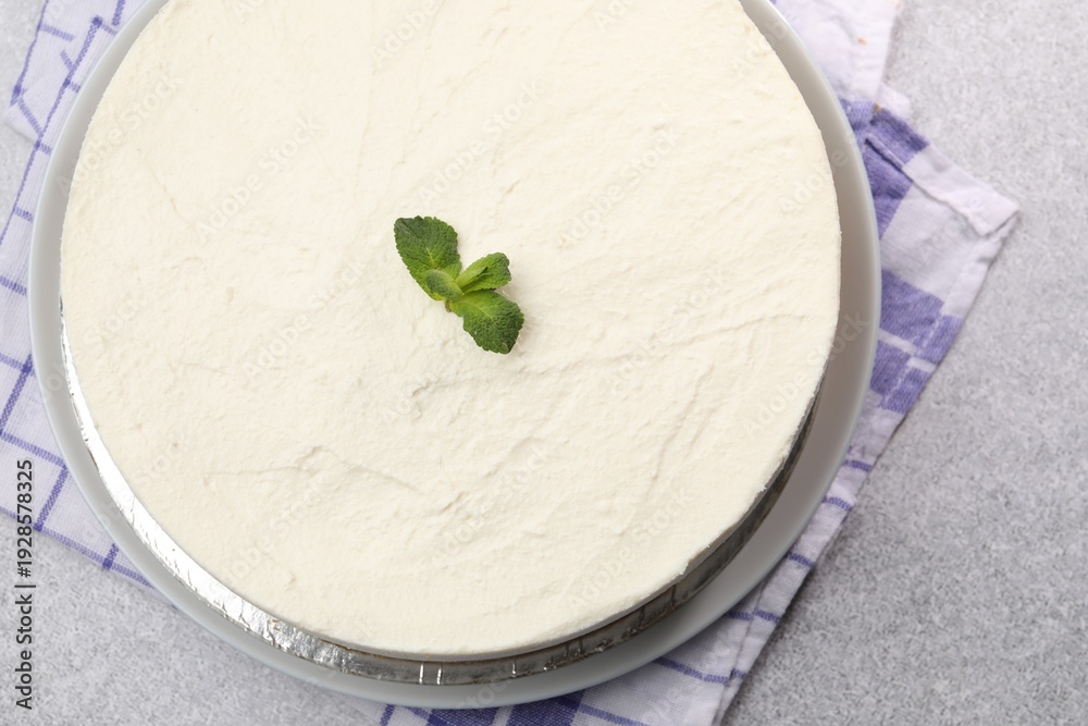 Fototapeta premium Yummy cheesecake with mint on grey table, top view