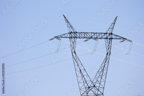High Voltage Power Line Tower with Electric Cables Against Clear Sky