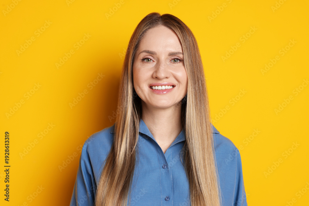 Fototapeta premium Portrait of beautiful woman on yellow background