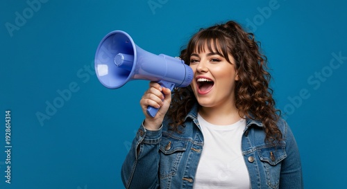 A young woman holding a megaphone and shouting loudly against a blue background