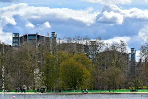 Cityscape, view of buildings behind bare trees on the river bank in spring, London, UK, April 2021
