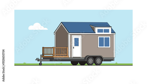 Tiny house on wheels with deck and blue roof in green landscape