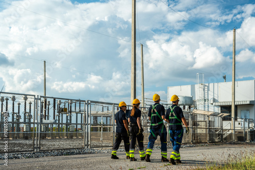 Bild auf Leinwand Electrical engineering team conducting walkdown at high-voltage substation facility