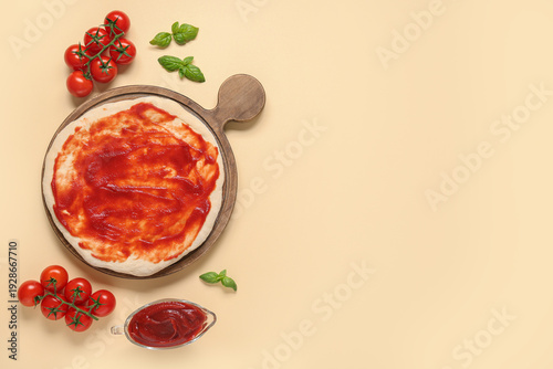 Raw pizza dough with tomato...