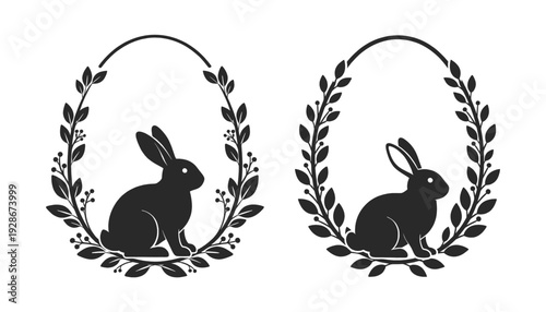 Two black silhouette rabbits in oval laurel wreaths on white background
