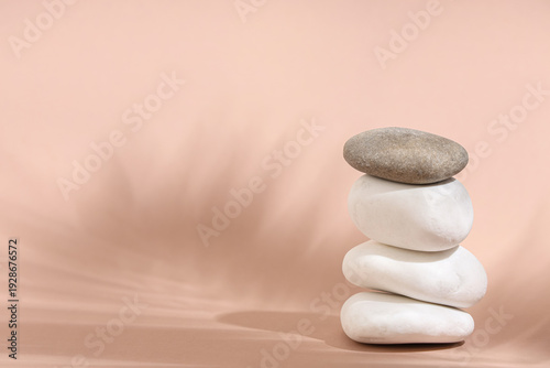 Stack of pebbles on beige b...