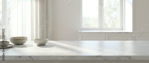 Empty white marble kitchen counter with ceramic bowls in bright modern interior with window light for product display and food photography.