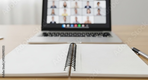 Open notebook pen and laptop displaying virtual meeting on screen ready for notes and online collaboration in modern workspace