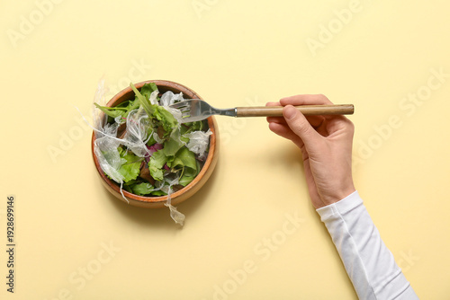 Female hand with bowl of sa...